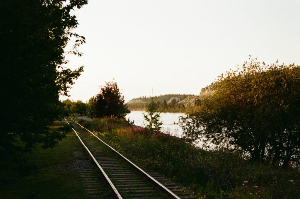 rail line reflecting the sunlight with the Yukon River alongside
