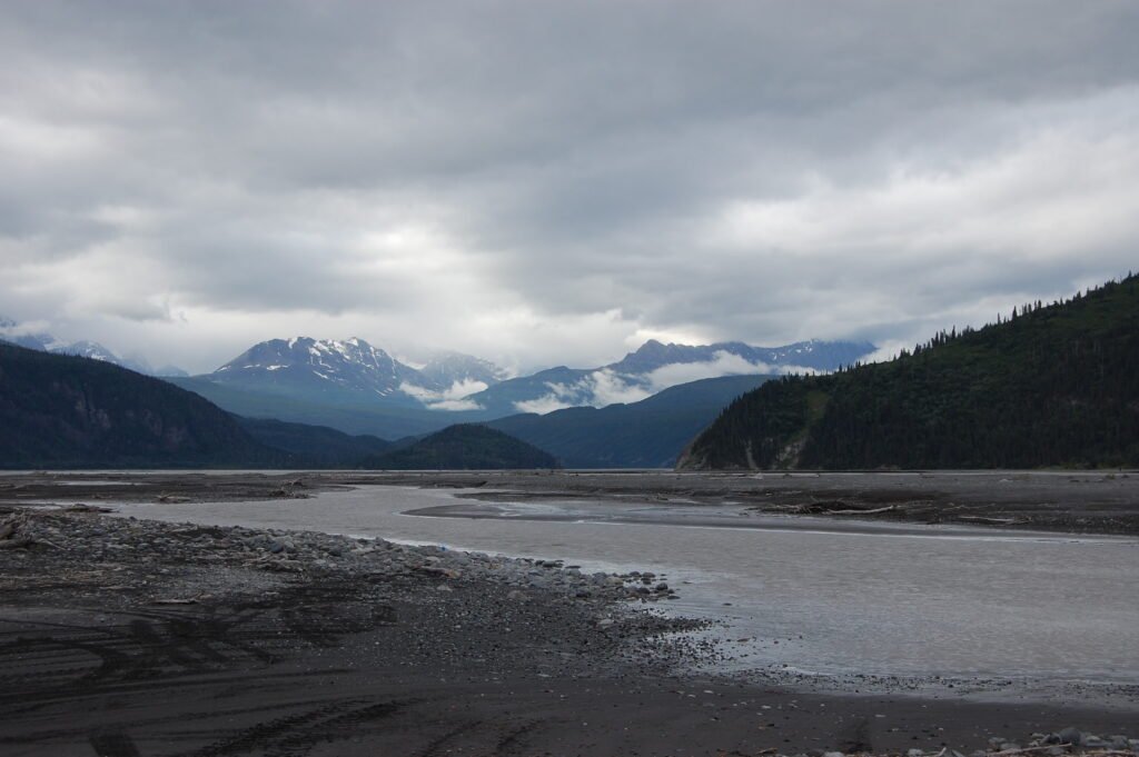 a braided river with mountains in the background