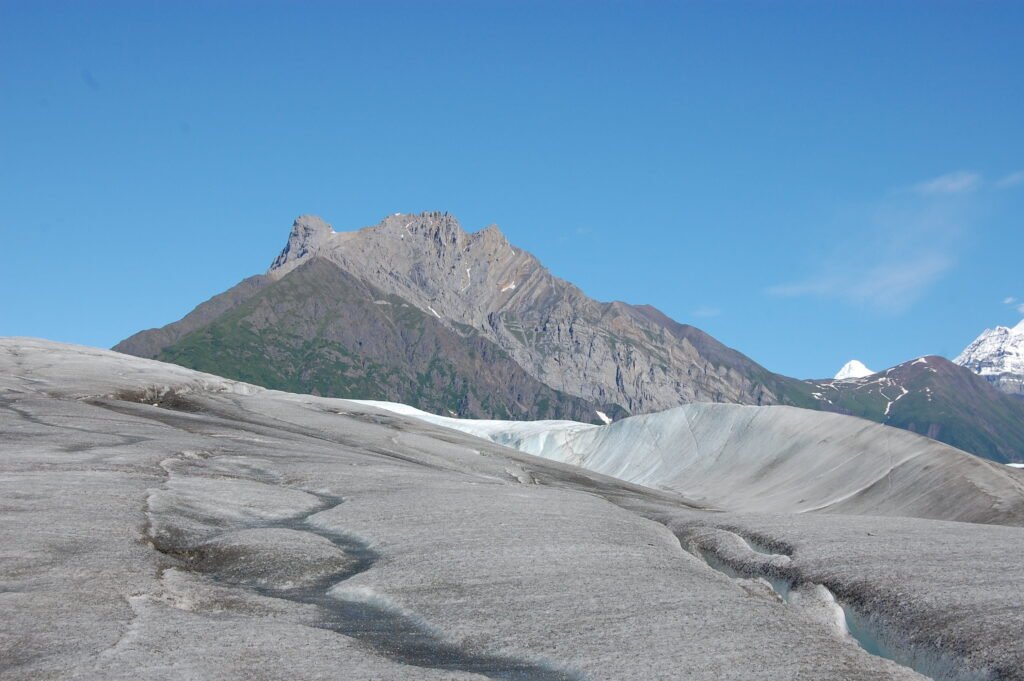 a glacier with a series of indentations and cracks