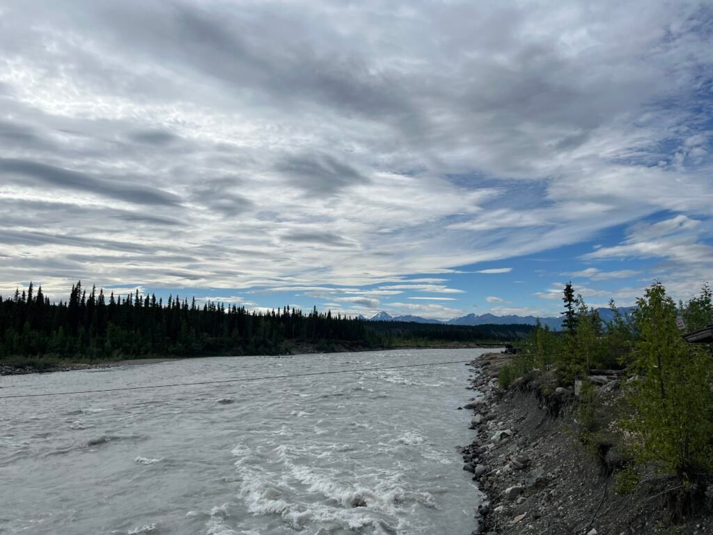 a river with mountains in the distance