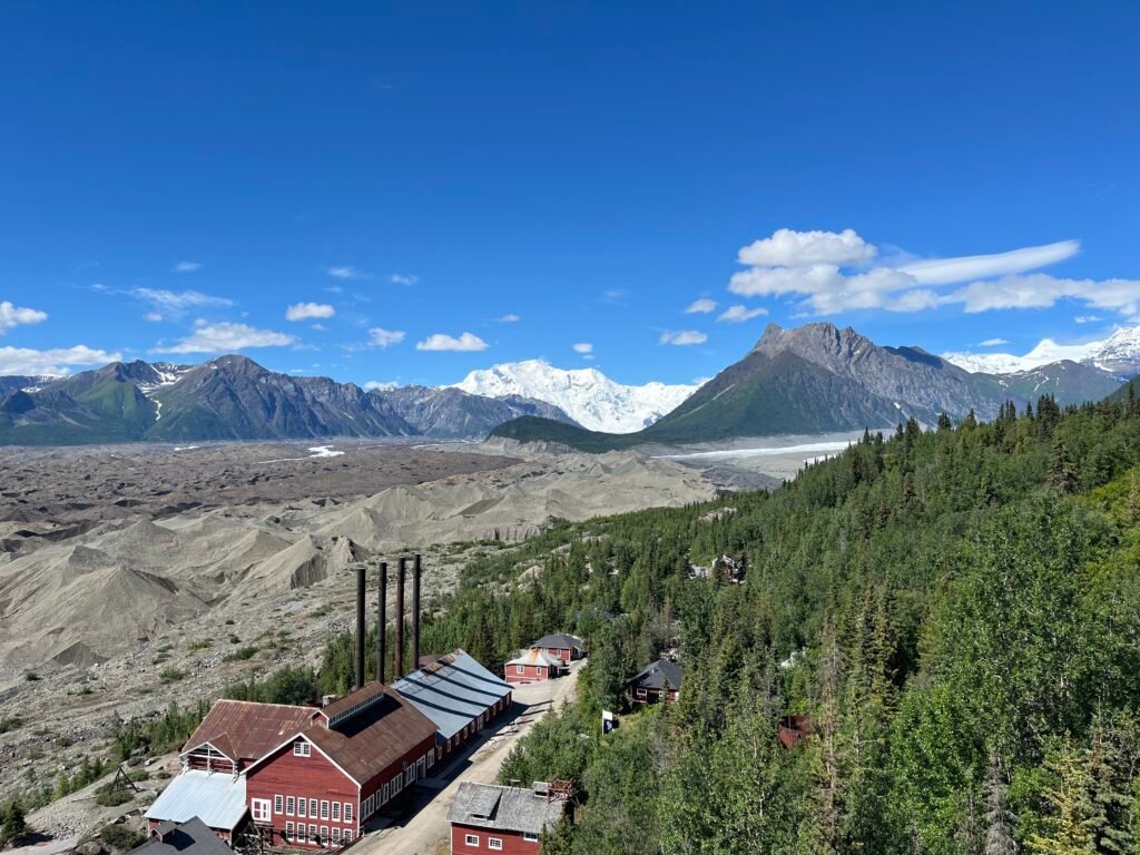 an old power plant building, other small miner's cabins, and glaciers